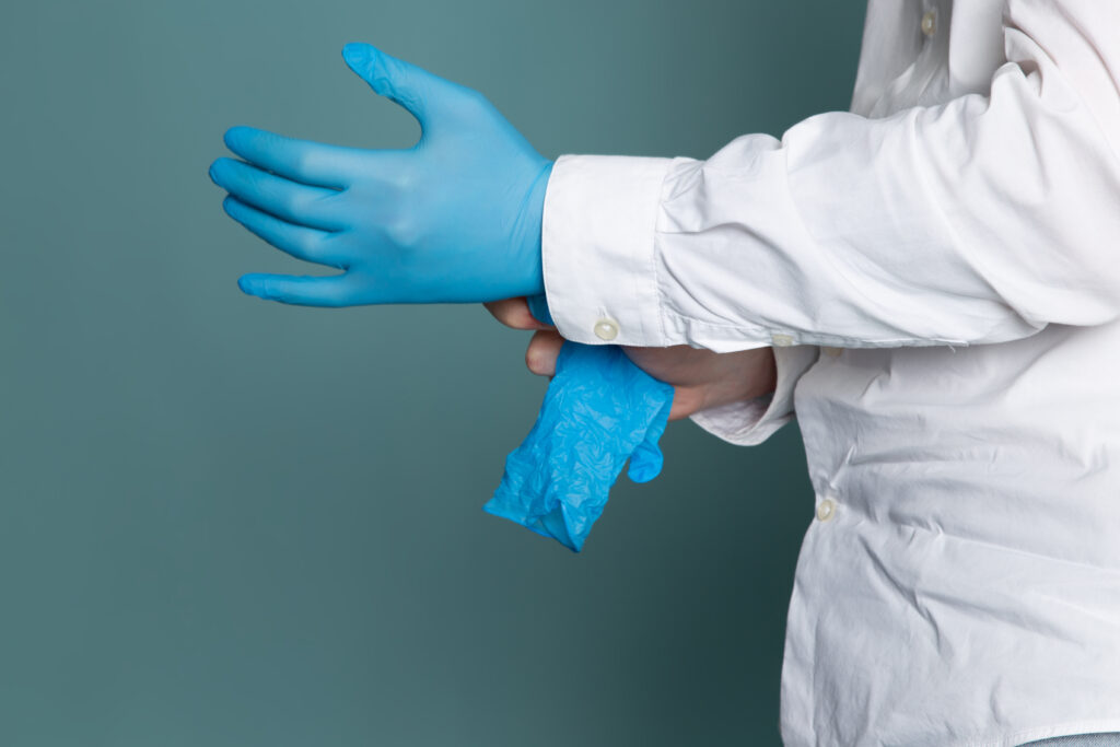 front-view-man-white-medical-suit-blue-gloves-blue-desk